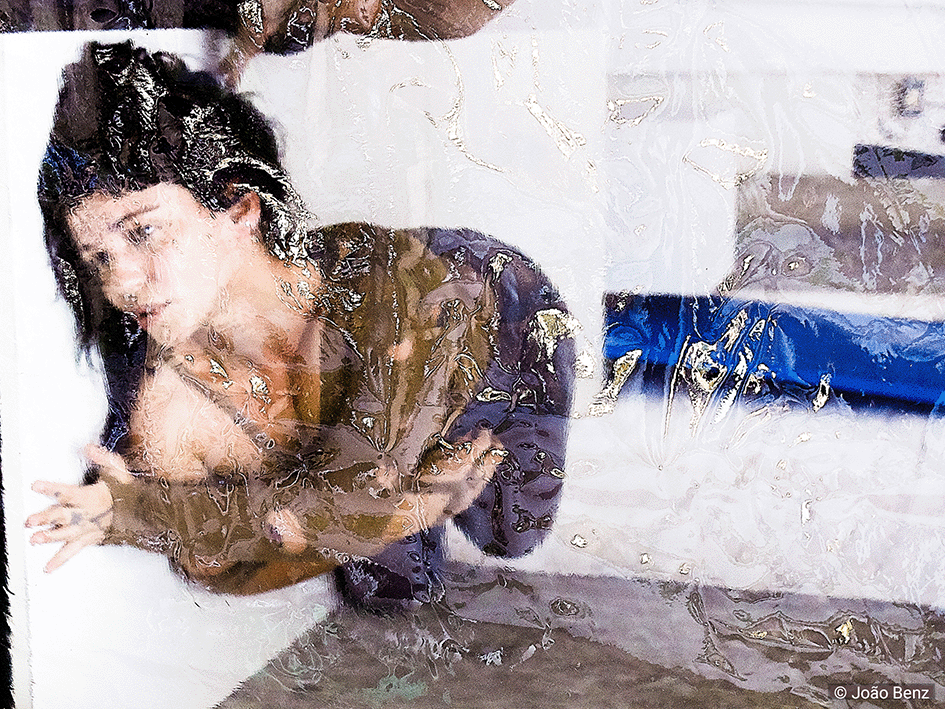 Person bent near a white wall, with arms flexed, seen through a translucent and wavy surface. Background with white, blue, and grey elements.